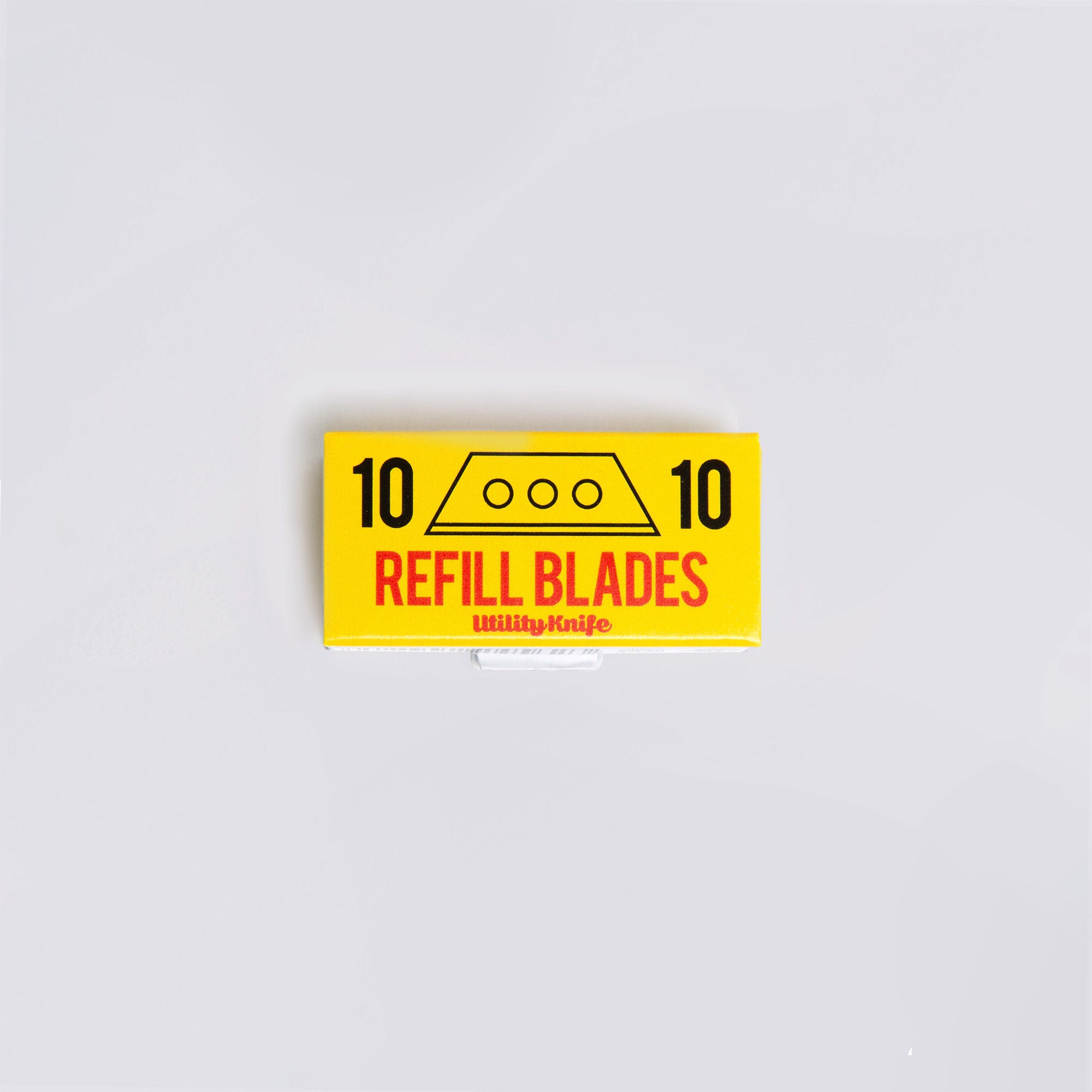 Eine rechteckige gelbe Box mit schwarzem Text, auf dem „10 REFILL BLADES“ und „Ersatzklingen: Cutter an der Kette“ stehen. Auf beiden Seiten ist eine Klinge abgebildet und die Zahl 10. Sie ist ideal für Ihr Penco Allzweckmesser und steht auf einem schlichten weißen Hintergrund.