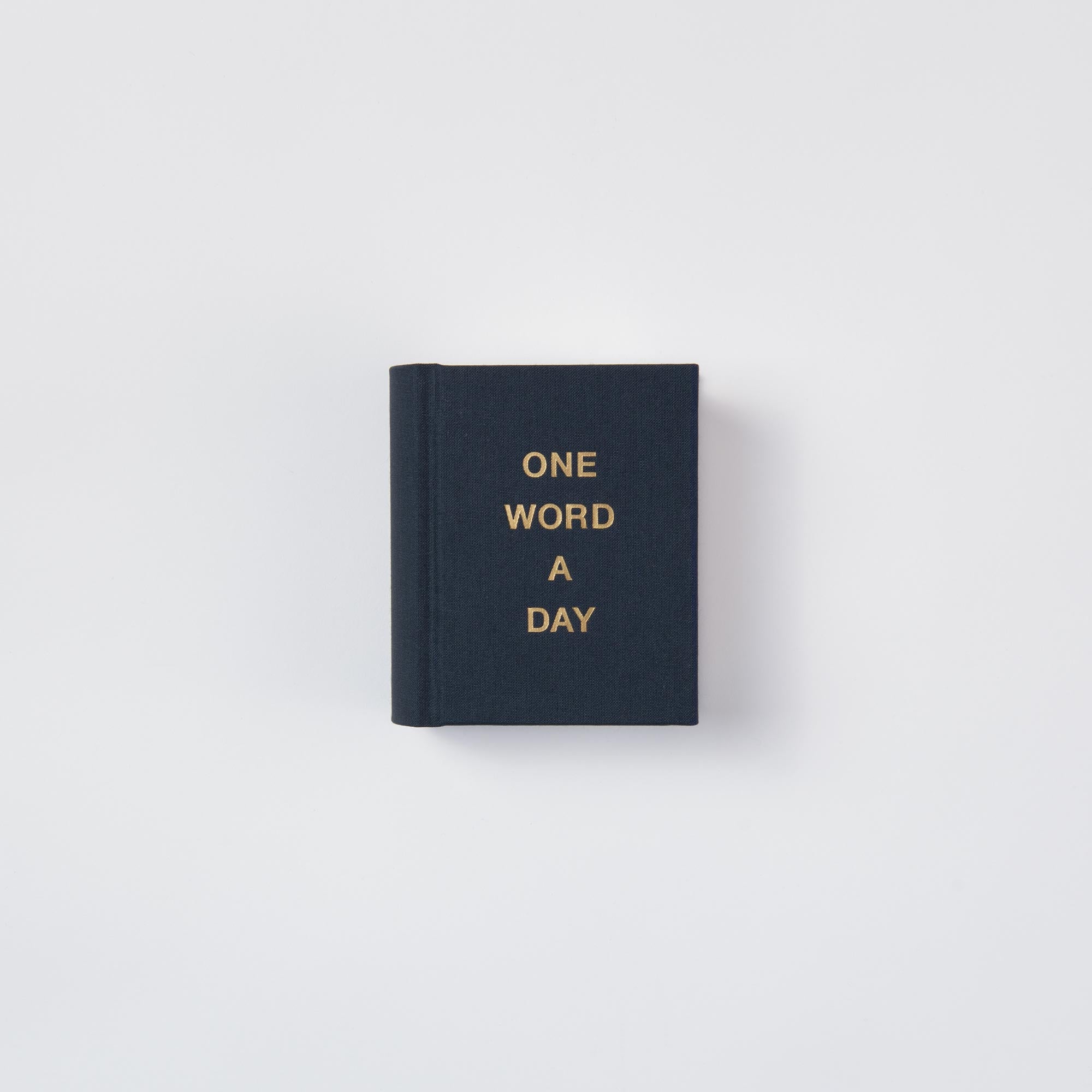 Der paperlux OWAD Klassiker ist ein kleines, handgefertigtes schwarzes Mini-Notizbuch mit goldenem ONE WORD A DAY-Schriftzug auf dem Umschlag, abgebildet auf einem schlichten weißen Hintergrund - das perfekte Geschenk.