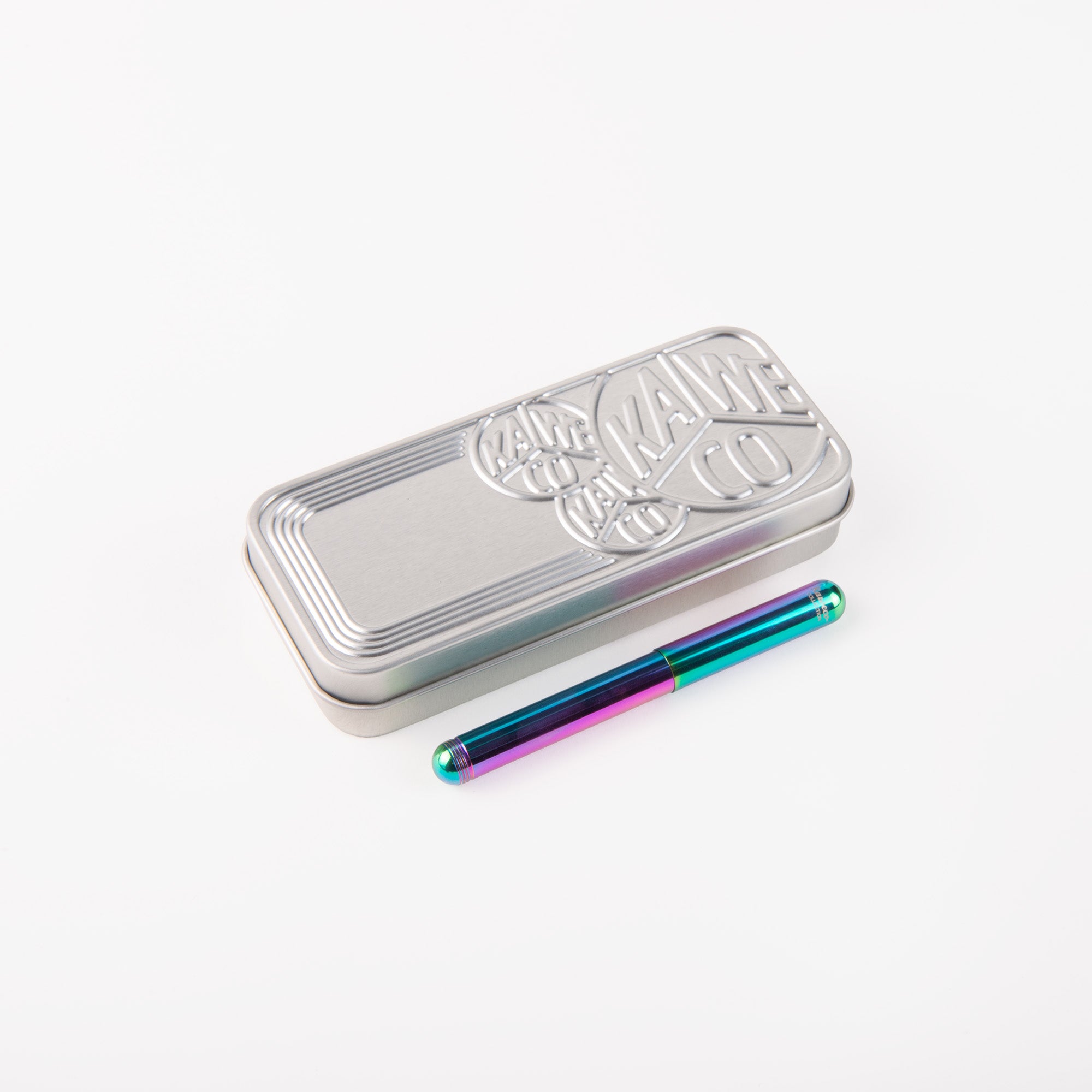 Eine rechteckige, silberne Kaweco-Dose mit geprägtem Text und ein davor platzierter, leuchtender Kaweco Liliput Kolibri Füllhalter aus Metall, beide auf weißem Hintergrund.