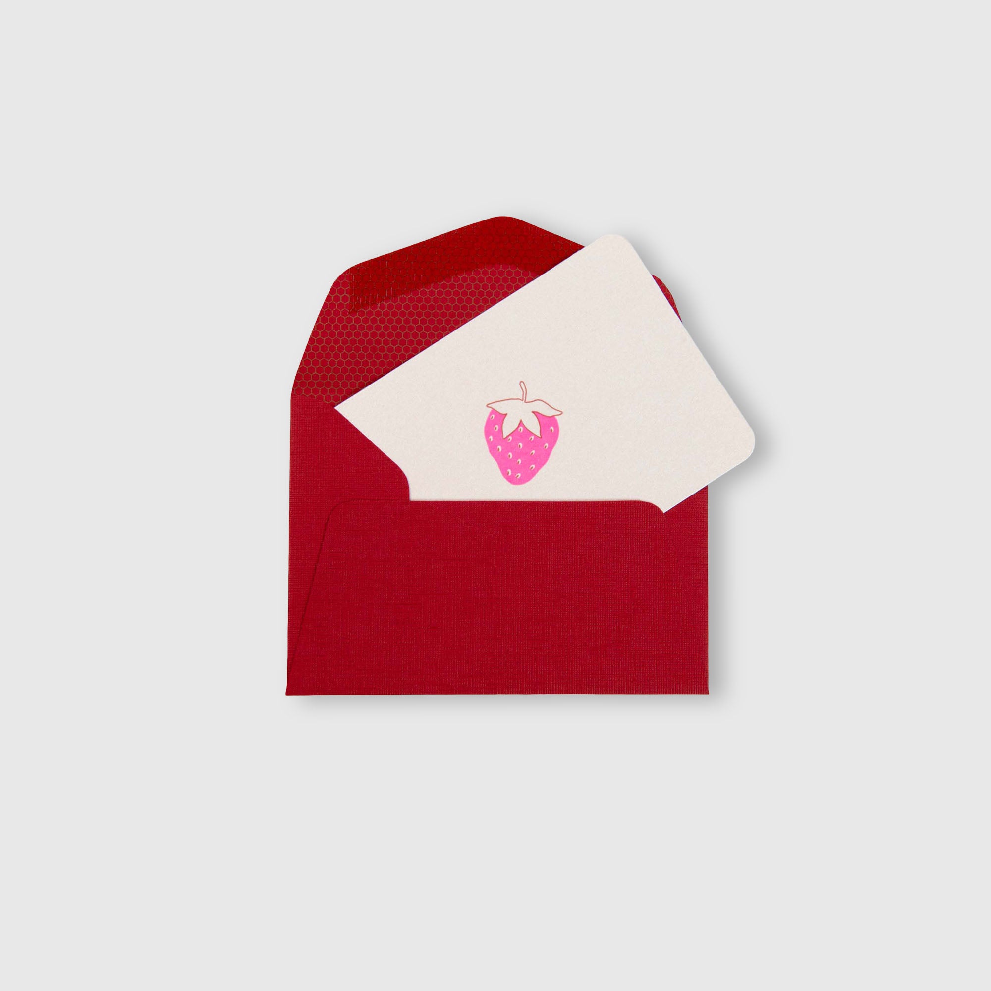 In einem roten Umschlag befindet sich die „Erdbeere – Mini-Karte“ von Le Typographe: eine cremefarbene Karte, die mit einer rosa Erdbeer-Illustration verziert ist und in elegantem Buchdruck gestaltet wurde. Der Hintergrund ist hellgrau.