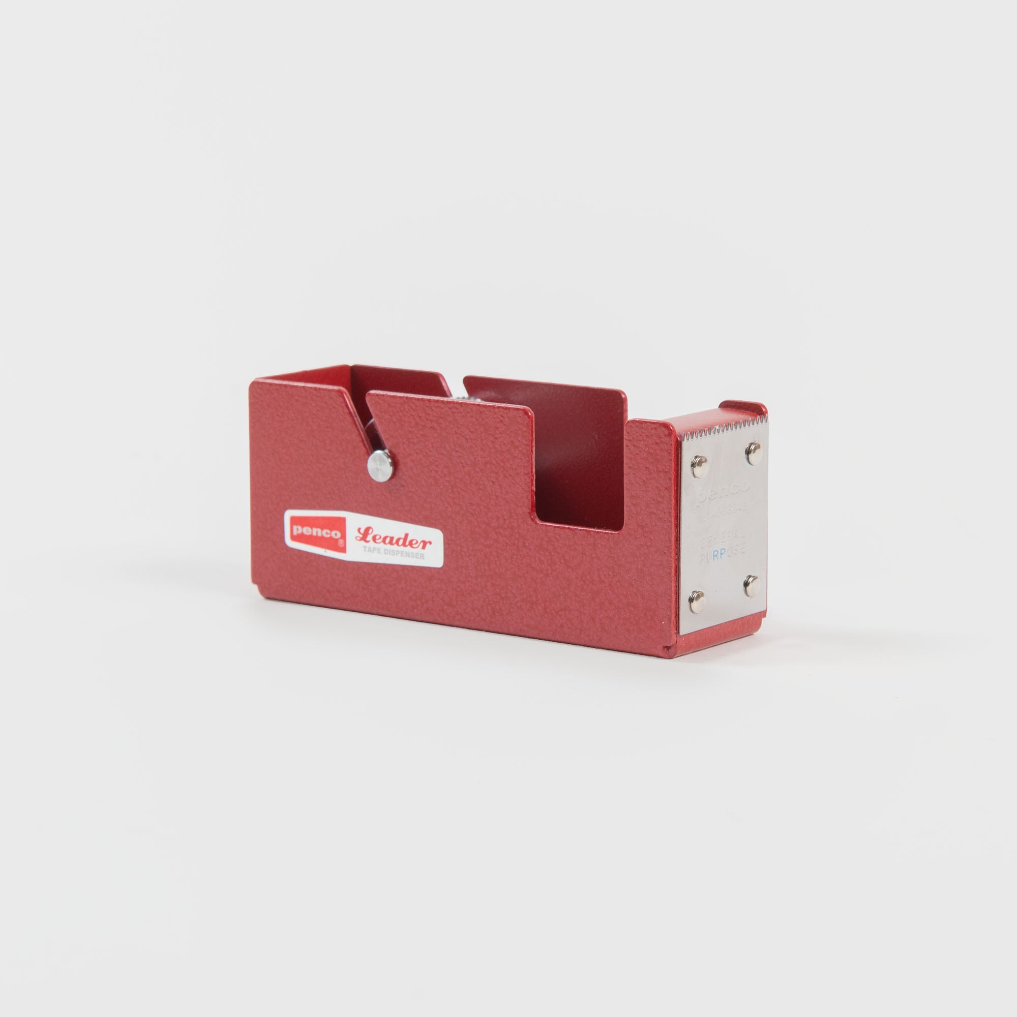 Der Klebebandabroller S - Klebebandabroller von Penco ist ein roter Metall-Tischabroller mit einer silbernen Schneidekante, ideal zum Einpacken von Geschenken. Er ist mit dem Schriftzug "Leader" versehen und wird vor einem schlichten weißen Hintergrund gezeigt.