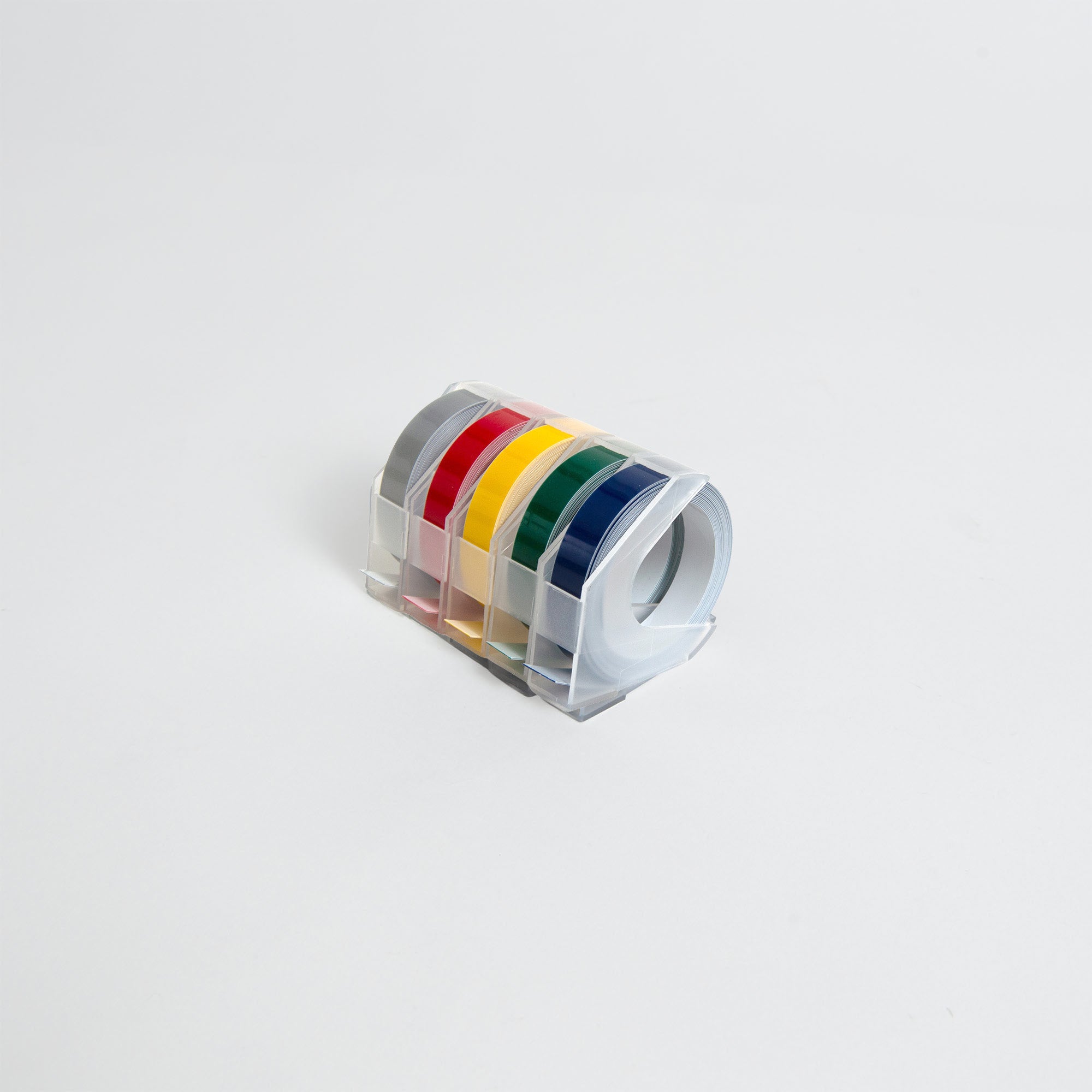 Fünf Rollen Penco Tape Writer Refill (9 mm), jeweils in einem durchsichtigen Spender in den Farben grau, rot, gelb, grün und blau von Penco, sind auf einem schlichten weißen Hintergrund angeordnet - perfekt für Ihren Penco Tape Writer.